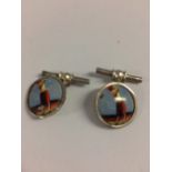 Pair of silver and enamel cufflinks depicting a lady golfer