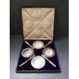 Cased set of four Edwardian butter dishes and knives (three with porcelain liners) by Carrington &