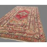 c1900 Anatolian carpet with central red medallion and all over geometric borders of browns, cream,