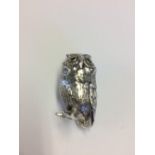 Cast silver figure of an owl with glass eyes