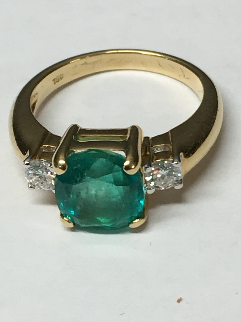 18 carat yellow gold, Columbian emerald and diamond ring; the central emerald of 2.8 carats