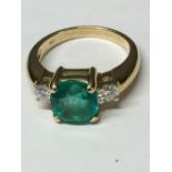 18 carat yellow gold, Columbian emerald and diamond ring; the central emerald of 2.8 carats