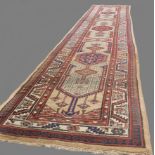 c1920's Persian Sarab runner carpet with geometric border and central design in reds, blue beige and