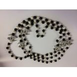 Long row of black and white freshwater pearls with Chanel style fittings