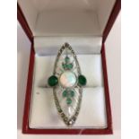 Silver ring set with cubic zirconia's, emeralds and a central opal in the Art Deco style