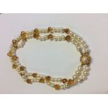 A two row cultured pearl necklace with citrine spacers