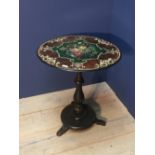 Early Victorian polychrome and ebonised centre table, the circular top painted with a floral spray