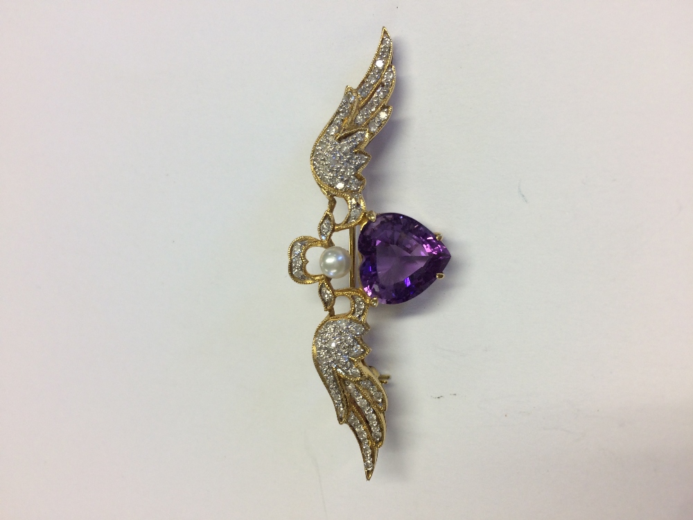 18 carat yellow gold sweetheart brooch set with a large amethyst and diamonds to the wings