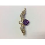 18 carat yellow gold sweetheart brooch set with a large amethyst and diamonds to the wings