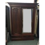 Continental mahogany empire style wardrobe with bevelled mirror door, above 2 base drawers. 165 w