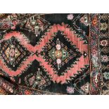 Old persian runner, with black/dark navy ground and striking diamond motifs in pinks/oranges and