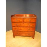 Victorian mahogany chest of drawers, with three-quarter galleried top about two short drawers and