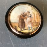 C19th tortoiseshell circular table snuff box; the cover inset with a painting of 2 figures in a