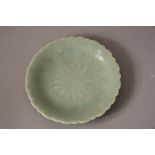 Chinese celadon-glazed 'chrysanthemum' dish, Qianlong six-character mark and period, 15.8cm dia.