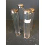 Set of 4 glass vanity bottles with hallmarked silver tops