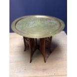 Eastern brass tray top occasional table, the top with Egyptian style engraved decoration on a