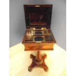 William IV rosewood teapoy, the moulded shaped top containing a fitted interior of four lidded