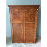 Victorian figured walnut wardrobe with a moulded cornice over a pair of panelled doors enclosing