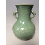 Chinese Celadon glazed twin handle vase with incised decoration of scrolling foliage, 30cmH