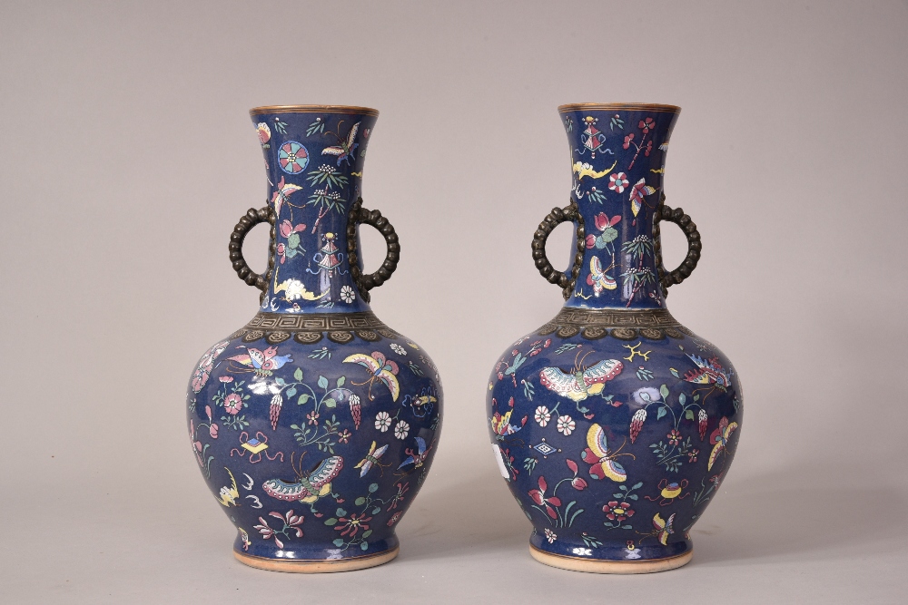 Pair of C18th/19th Chinese famille rose vases flanked by twin handles, decorated with butterflies