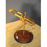 Brass decanter cradle on wooden stand