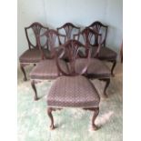 Set of six mahogany shield back dining chairs with over-stuffed seats on carved cabriole legs with