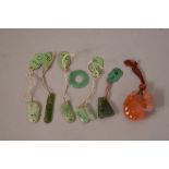 Five Chinese jadeite carvings and a carnelian agate 'squirrel and grape' carving.