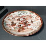 Japanese Kutani plate decorated with figures in a landscape 33cm dia