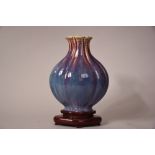 C18th/19th Chinese flambe glazed lobed vase, 24.5cm high, wood stand.