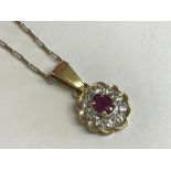 18ct yellow gold ruby and diamond pendant necklace on 9ct yellow gold chain