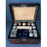 C19th rosewood travelling vanity box fitted with various glass bottles with silver plated mounts
