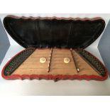 Early C20th Chinese red and black lacquered string musical instrument, the case decorated with