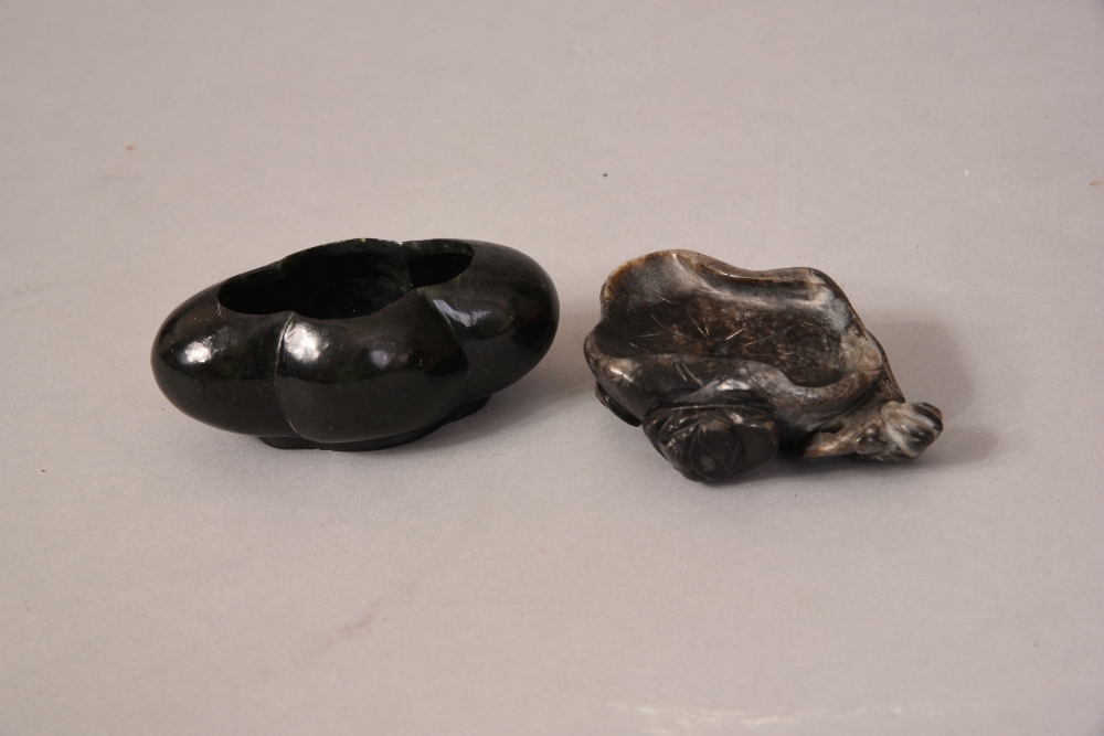 Two Chinese dark green jade brush pots, one carved as lotus leaf-form 7cm wide, and the other with