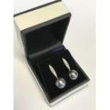 Pair of white gold south sea pearl and diamond earrings