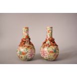 Pair of C19th Chinese famille rose 'mille fleur' bottle vases applied with dragon on the neck,