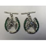 Pair of silver horse shoe and emerald cufflinks