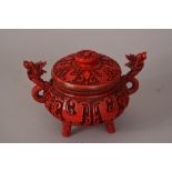 C20th Chinese cinnabar lacquer tripod incense burner carved with kuifeng and flanked by a pair of '