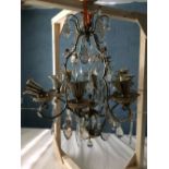 Gilt metal 8 branch chandelier in the Italianate taste with glass pendant drops