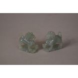 Pair of C20th Chinese carved jadeite Buddhist lions, 5cm high. (2)