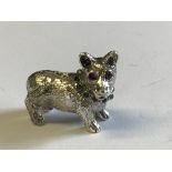 Cast silver figure of a dog with emerald collar & ruby eyes