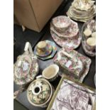 Quantity of floral chintz teawares & pair of fireside ornaments