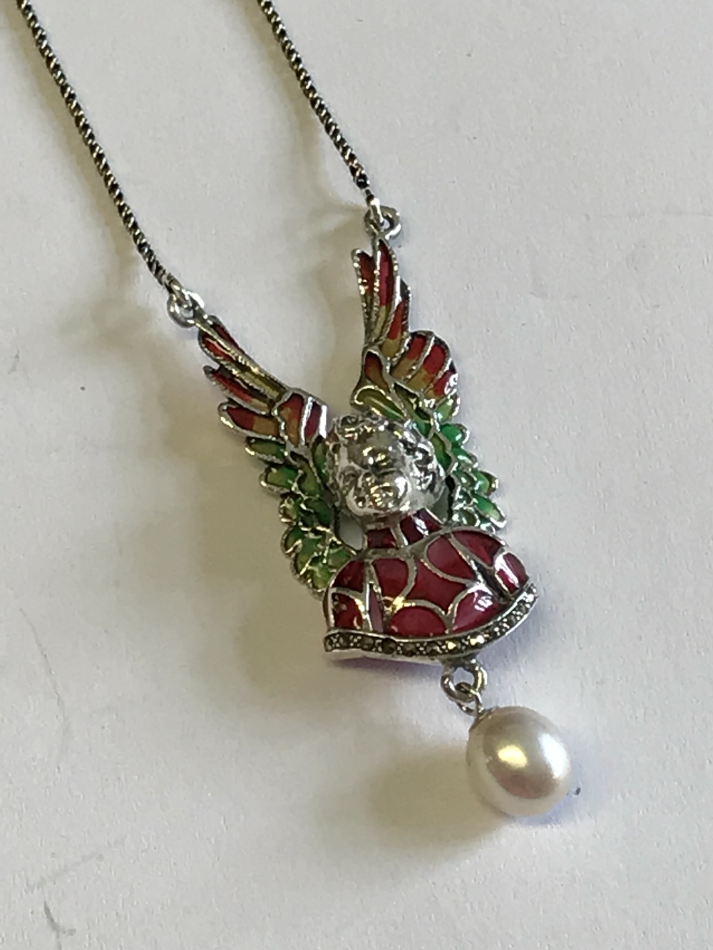 Silver necklace in the form of a winged cherub with freshwater pearl drop