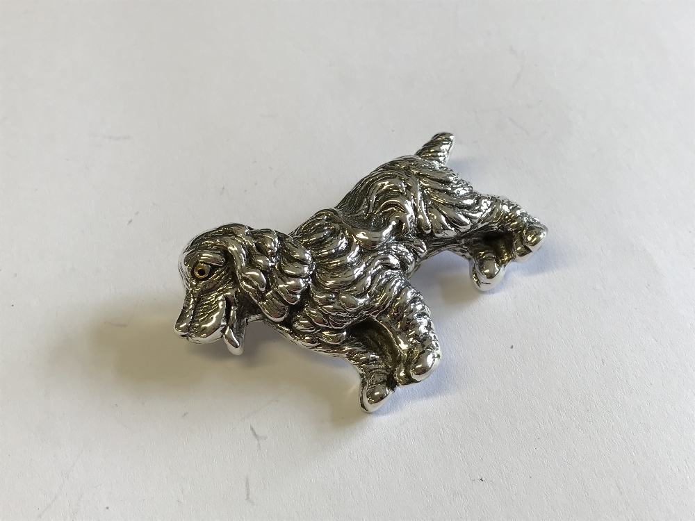 Silver brooch in the form of a dog with glass eye