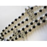 Long row of freshwater black & white pearls with cubic zirconia spacers in the designer style