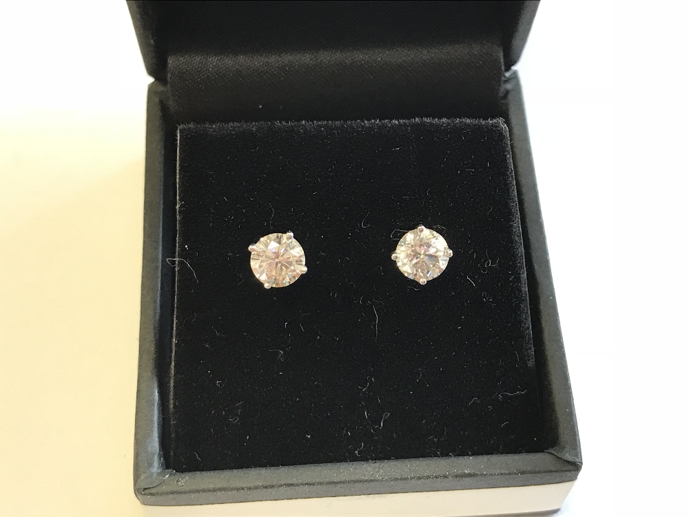 Pair of 14 carat white gold & diamond stud earrings of 1.5 carats approx.