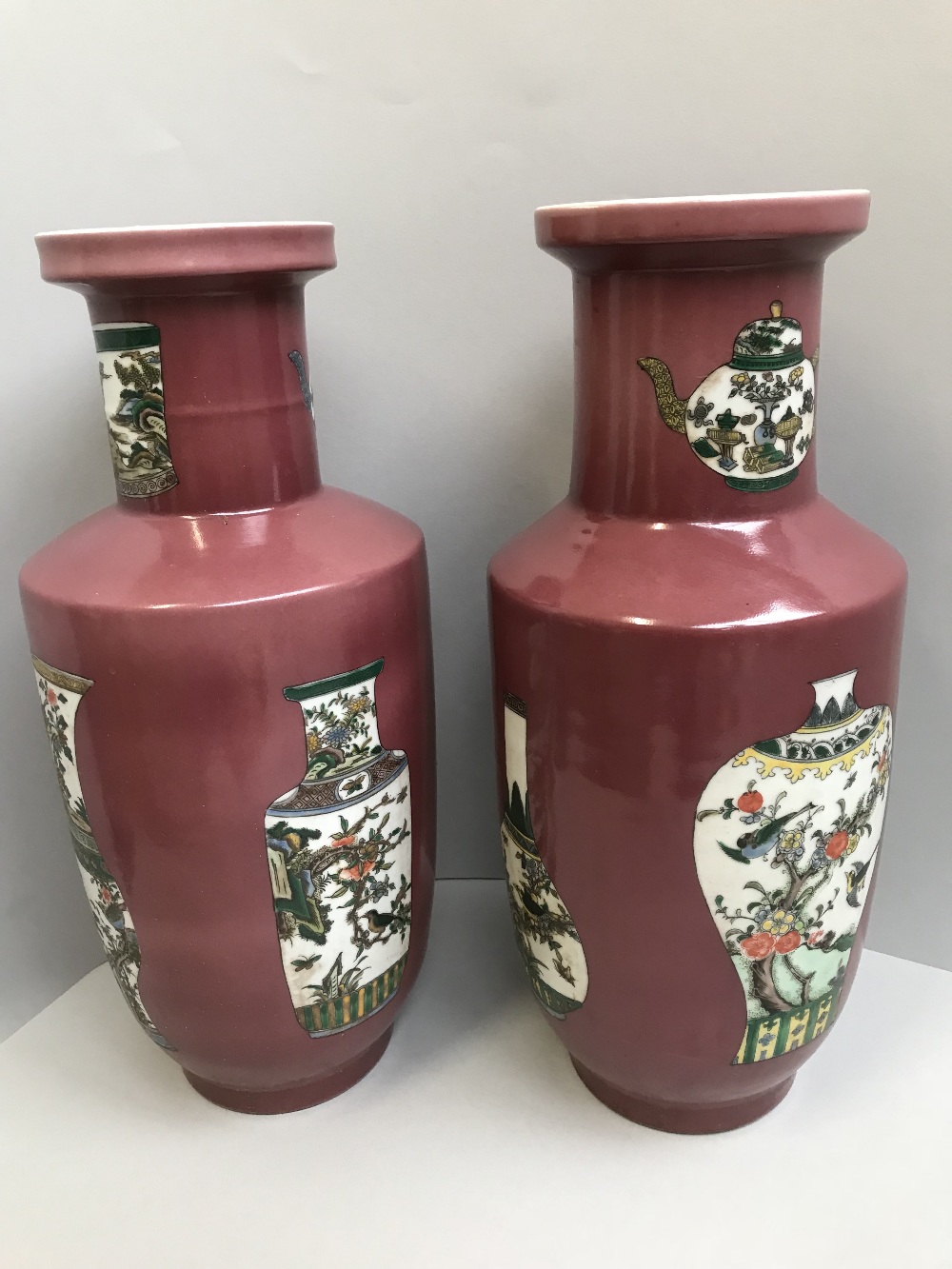 Pair of Chinese Rouleau vases decorated with landscapes & vases on a peach ground, 6 character marks