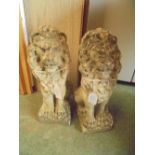 Pair of stone garden figures of seated lions 38cm high together with a pair of concrete planters