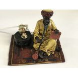 Cold painted bronze of an Arab figure on a rug