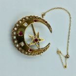 Unmarked yellow metal moon brooch set with old cut diamond, rubies & split pearls 9.0g