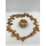 Collection of amber like items, panel bracelet & bead necklace